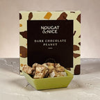 Box of Nougat & Nice dark chocolate peanut nougat on a light background