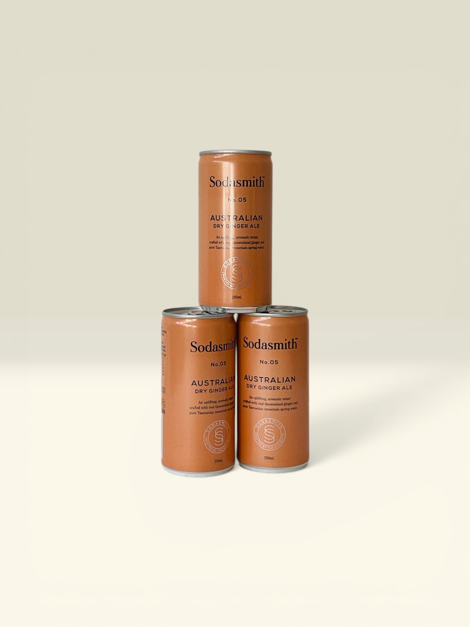 Three cans of Sodasmith Australian Dry Ginger Ale on a white background